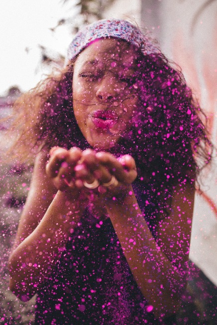 Woman blowing glitter