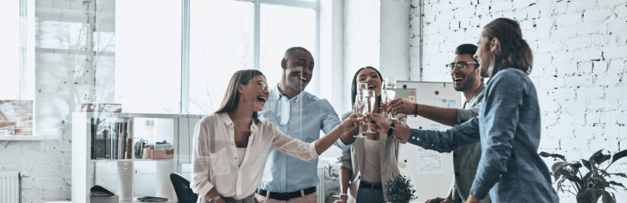 Blog Header image, group of five people cheersing glasses of bubbly in an office environment